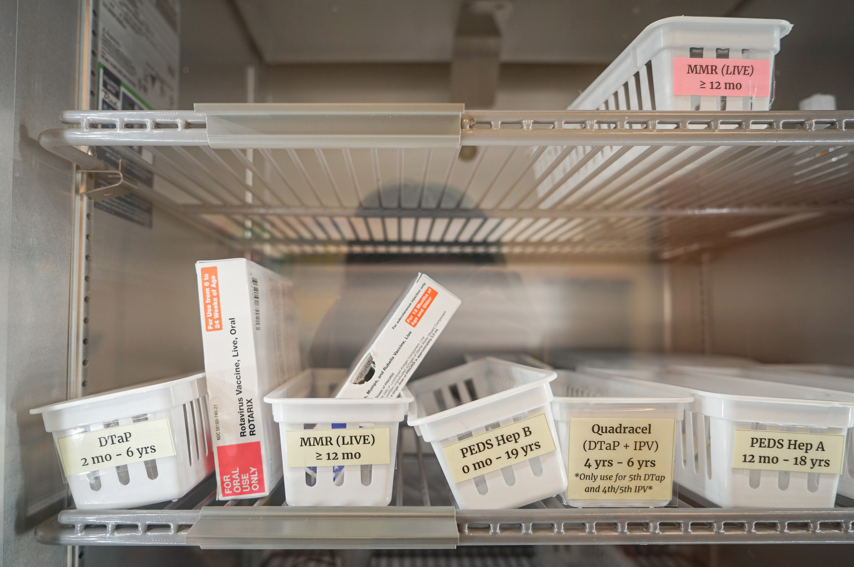 A photo of vaccines stored in a refrigerator.