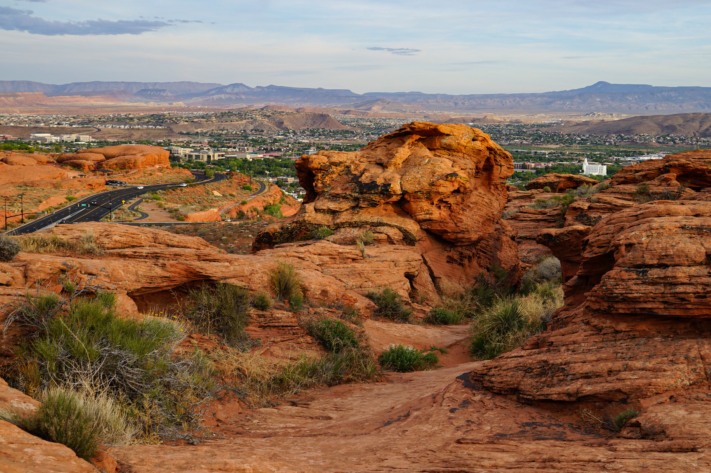A view of rocky formations along a road leading into a town in southwest Utah.